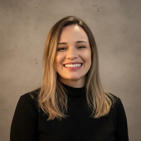 The same woman as a studio headshot on a neutral grey backdrop